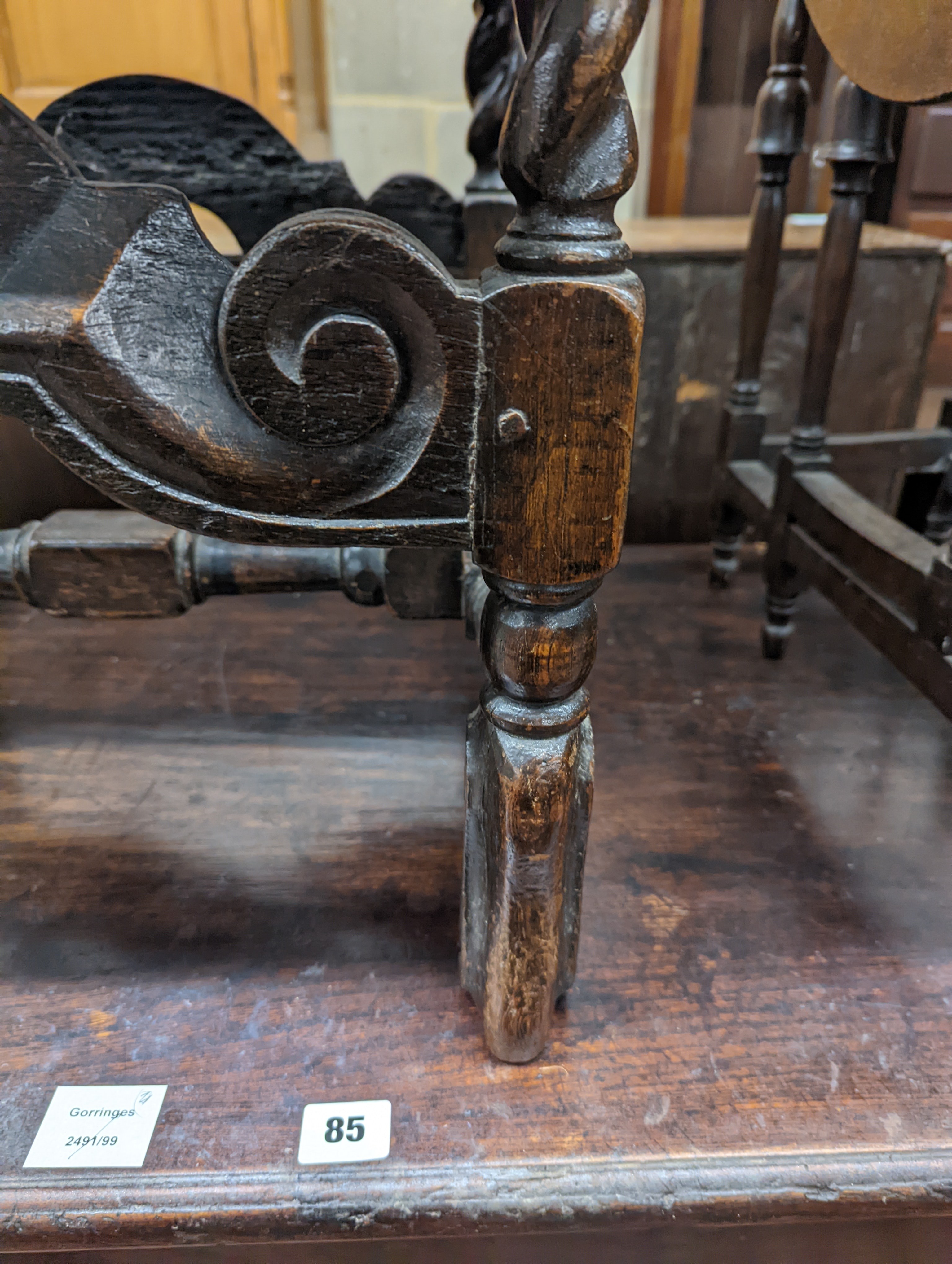 A 17th century style carved oak stool, with caned seat and H stretcher, width 47cm, depth 46cm, height 42cm